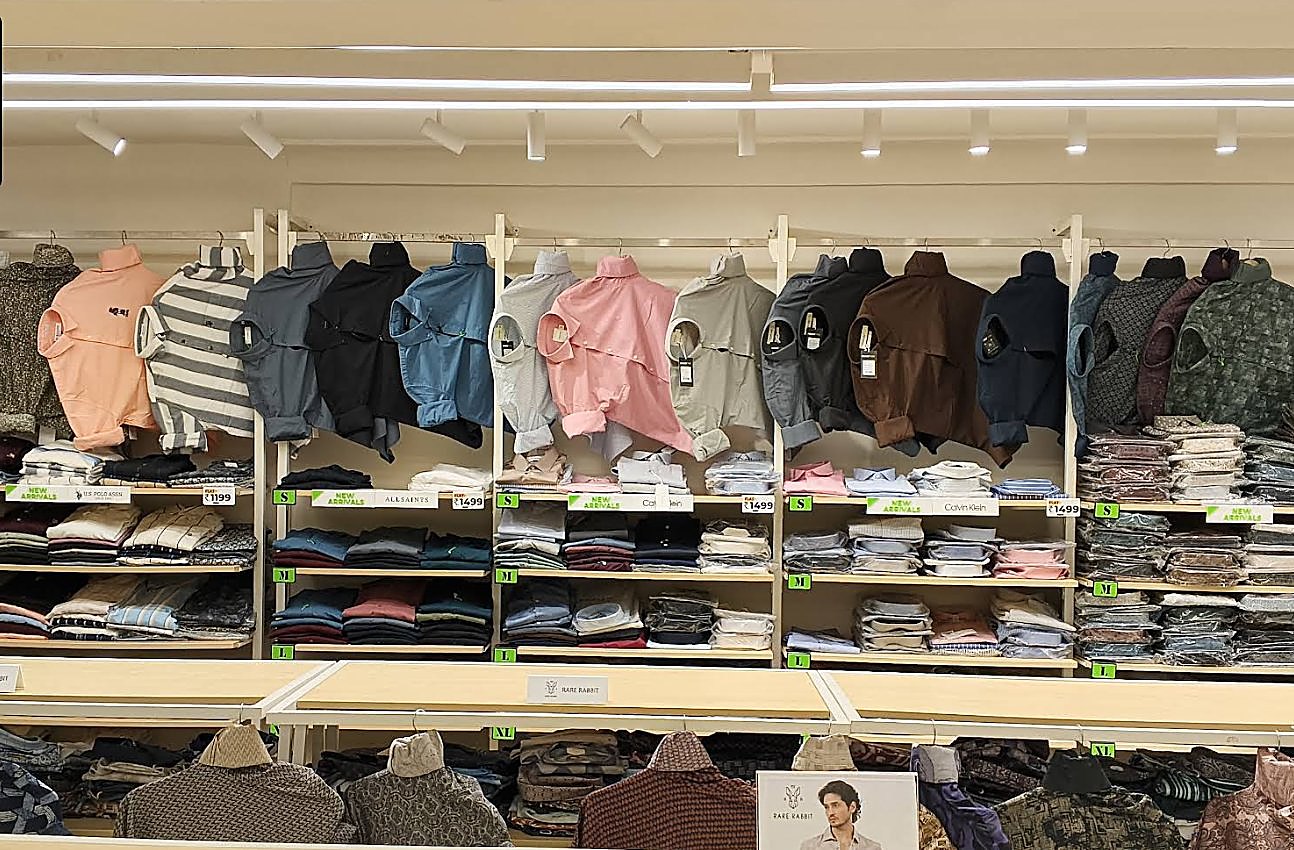 Folded shirts on display with price tags at Brandz Store